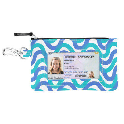 Wavy patterned pouch with zipper and keychain, featuring an ID card inside.