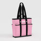 Pink patterned tote bag with black handles and trim on a light gray background