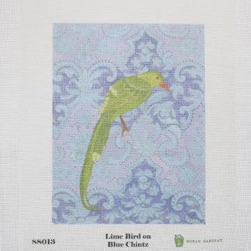 needlepoint lime bird on blue fabric with a pattern