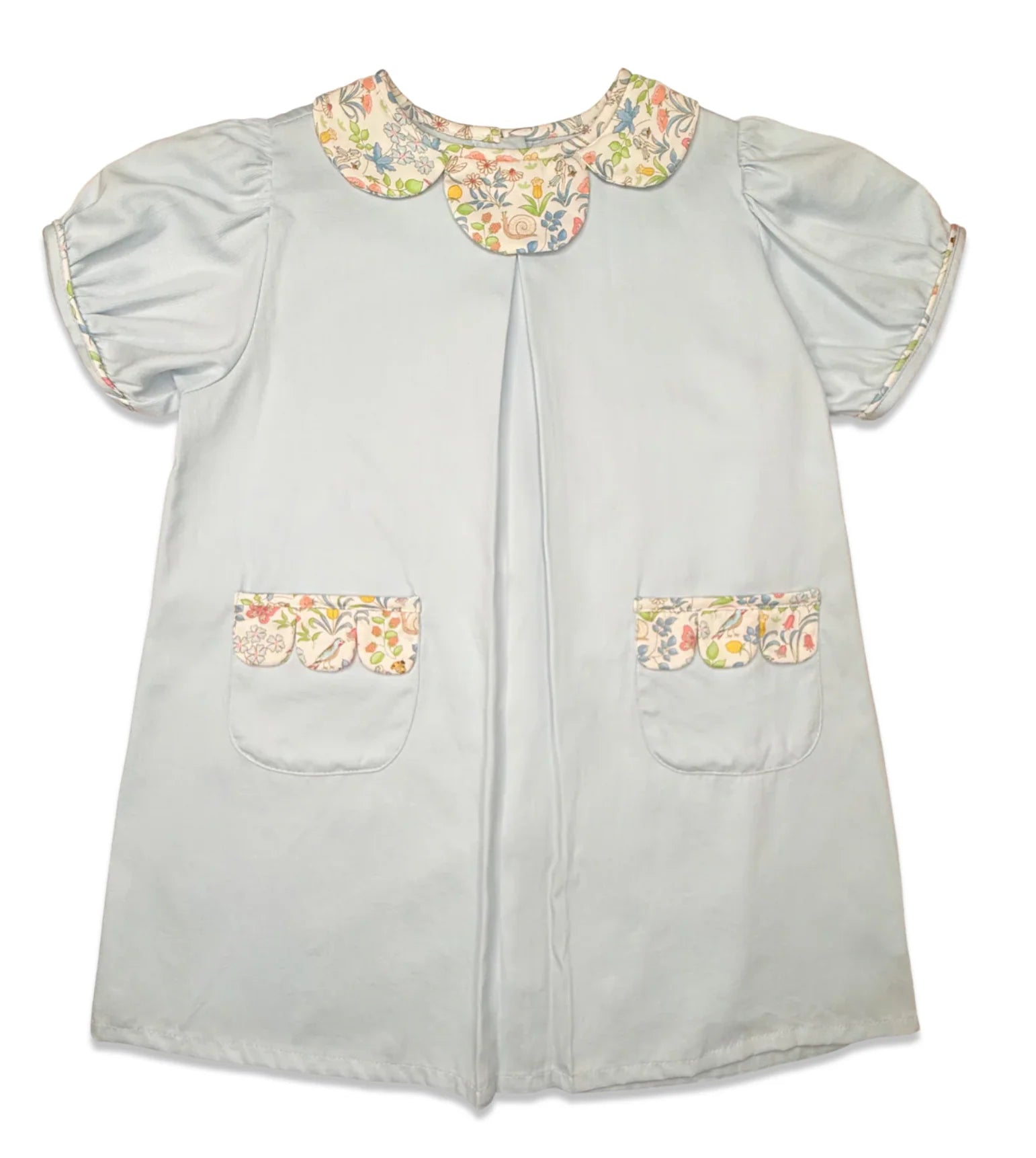 A light blue children's dress with short puff sleeves, a floral-patterned Peter Pan collar, and matching floral trim on the pocket flaps, shown against a plain white background.