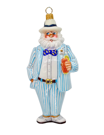 A vintage-style glass ornament depicting a santa with a white beard wearing a light blue and white pinstripe suit, a white hat with a blue band, and a blue patterned bow tie, holding a sweet tea drink.