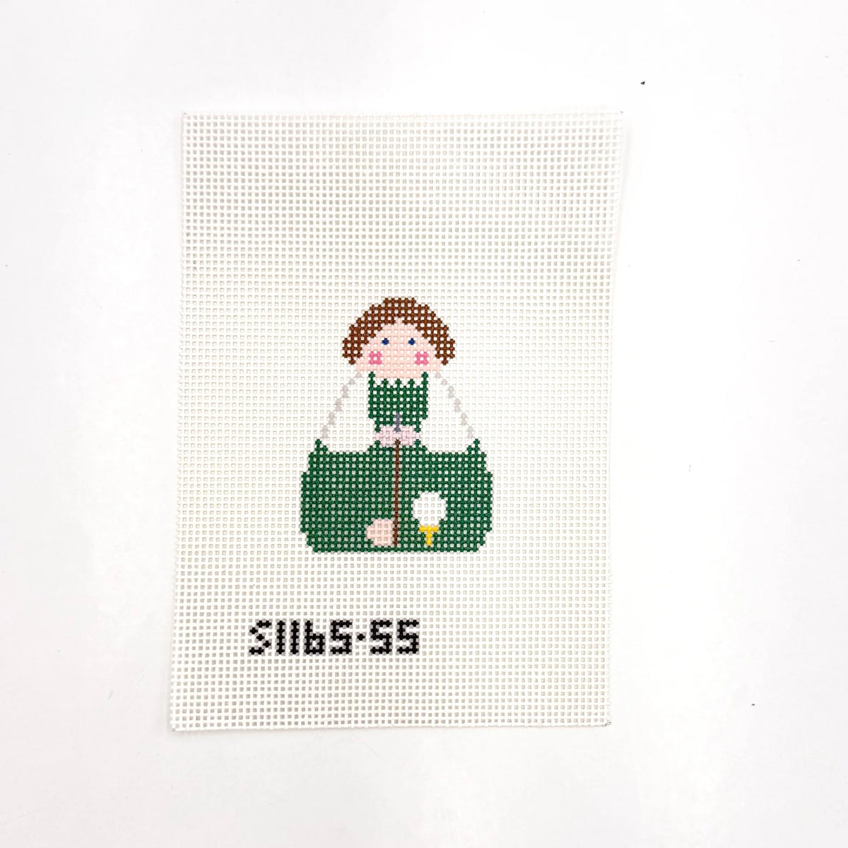 A square white needlepoint canvas with a girl with brown hair that is golfing painted on it.