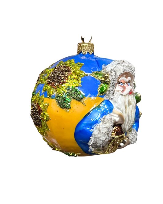 Decorative ornament with a character on a globe against a white background