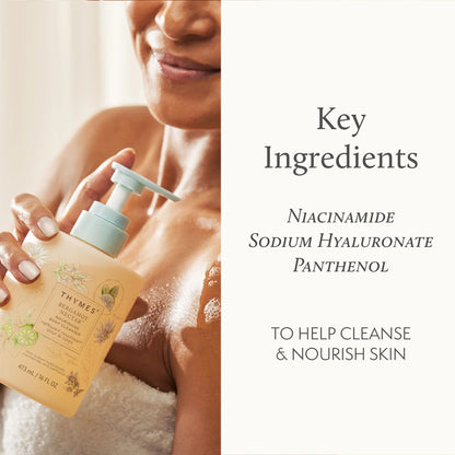 Person holding a bottle of Thymes product with key ingredients listed on a white background