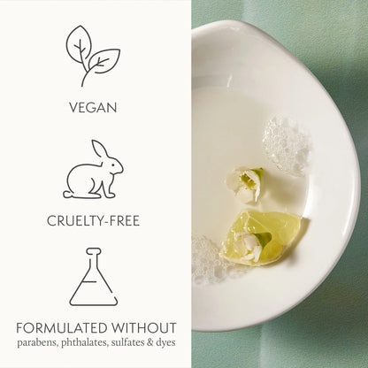 Product with vegan, cruelty-free, and sulfate-free labels on a white plate with a green background.