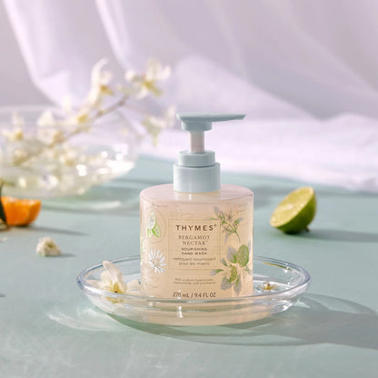 Thymes hand wash bottle with pump on a glass dish with decorative elements