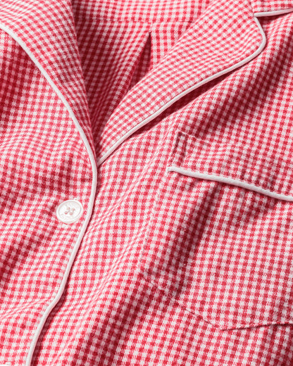 Close-up of a red and white checkered fabric with a button.
