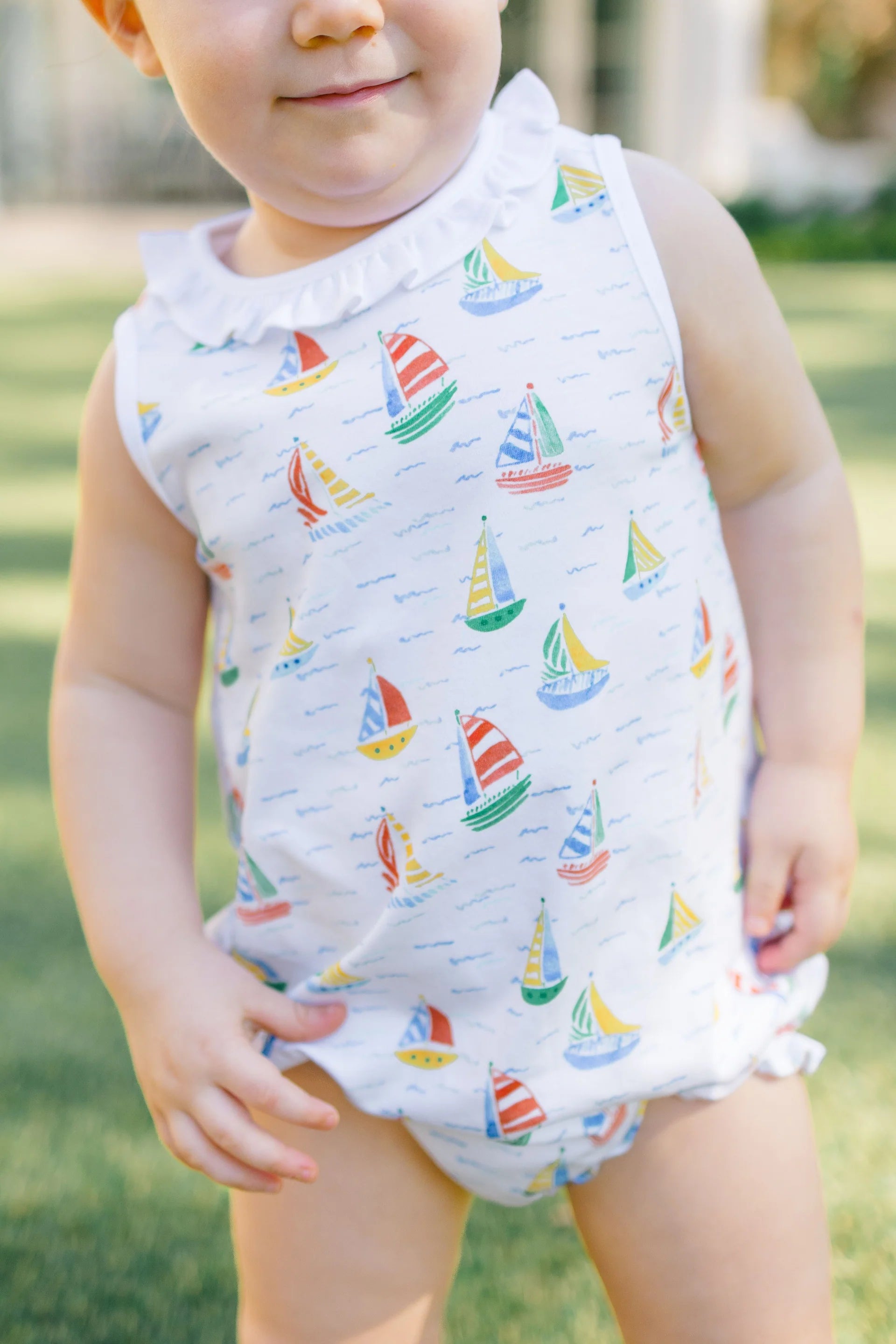 White one piece outfit with sailboat pattern