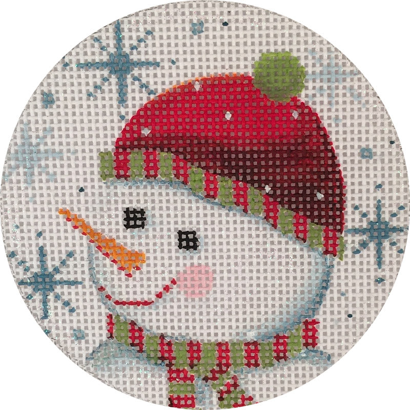Decorative needlepoint of a snowman with a red hat and plaid scarf on a checkered background.