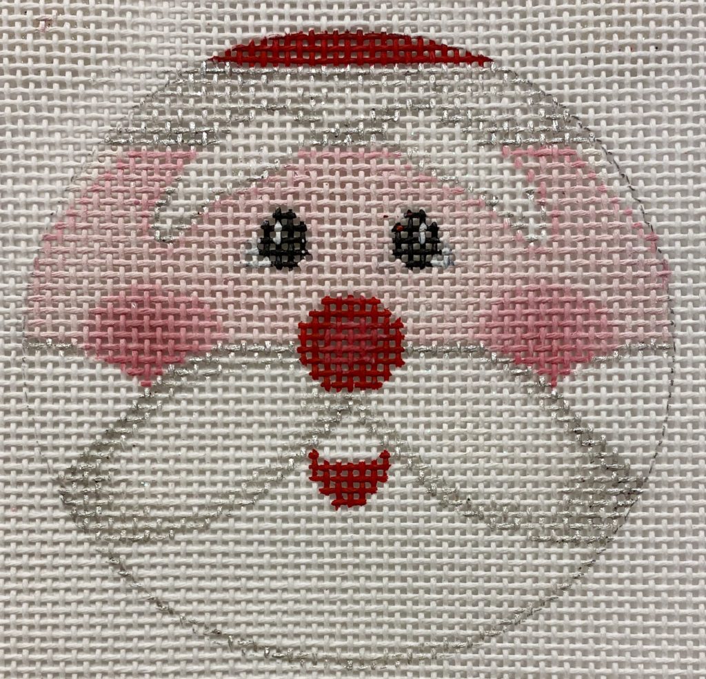 Cross-stitched design of a dog's face on fabric