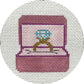Embroidered design of a pink jewelry box with a blue gemstone on a white background