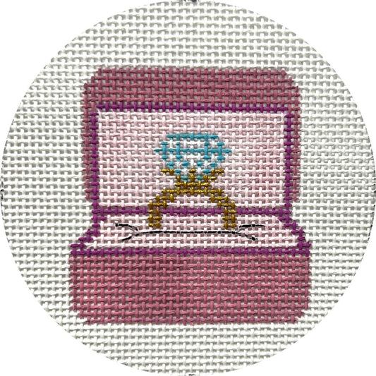 Embroidered design of a pink jewelry box with a blue gemstone on a white background