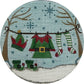 Circular needlepoint design of Christmas-themed clothing on a clothesline with a snowy background.