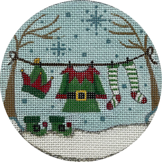 Circular needlepoint design of Christmas-themed clothing on a clothesline with a snowy background.