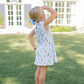 Girl in white dress with sailboat pattern
