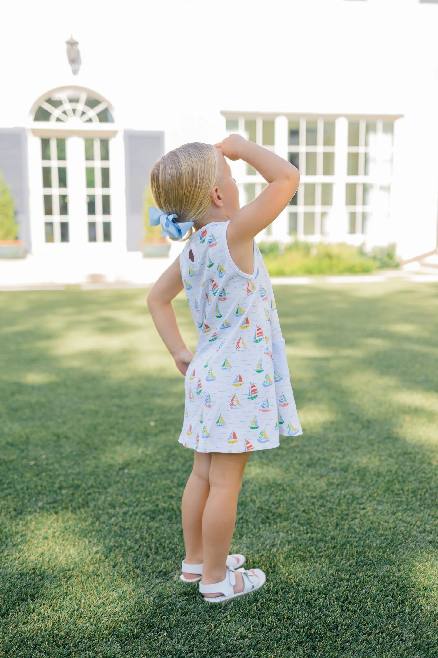 Girl in white dress with sailboat pattern
