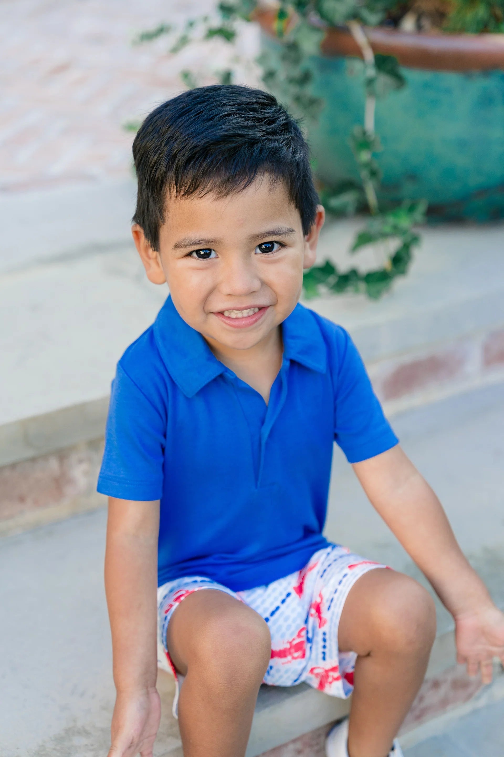 Blue short sleeve polo styled with blue and white shorts with red lobster pattern
