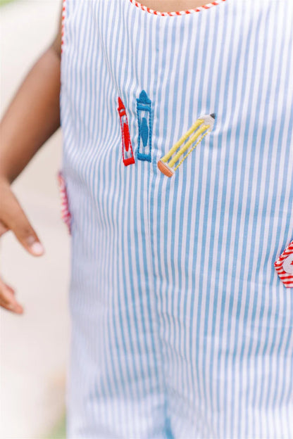 Close-up of a child's outfit with striped pattern and colorful crayon design.