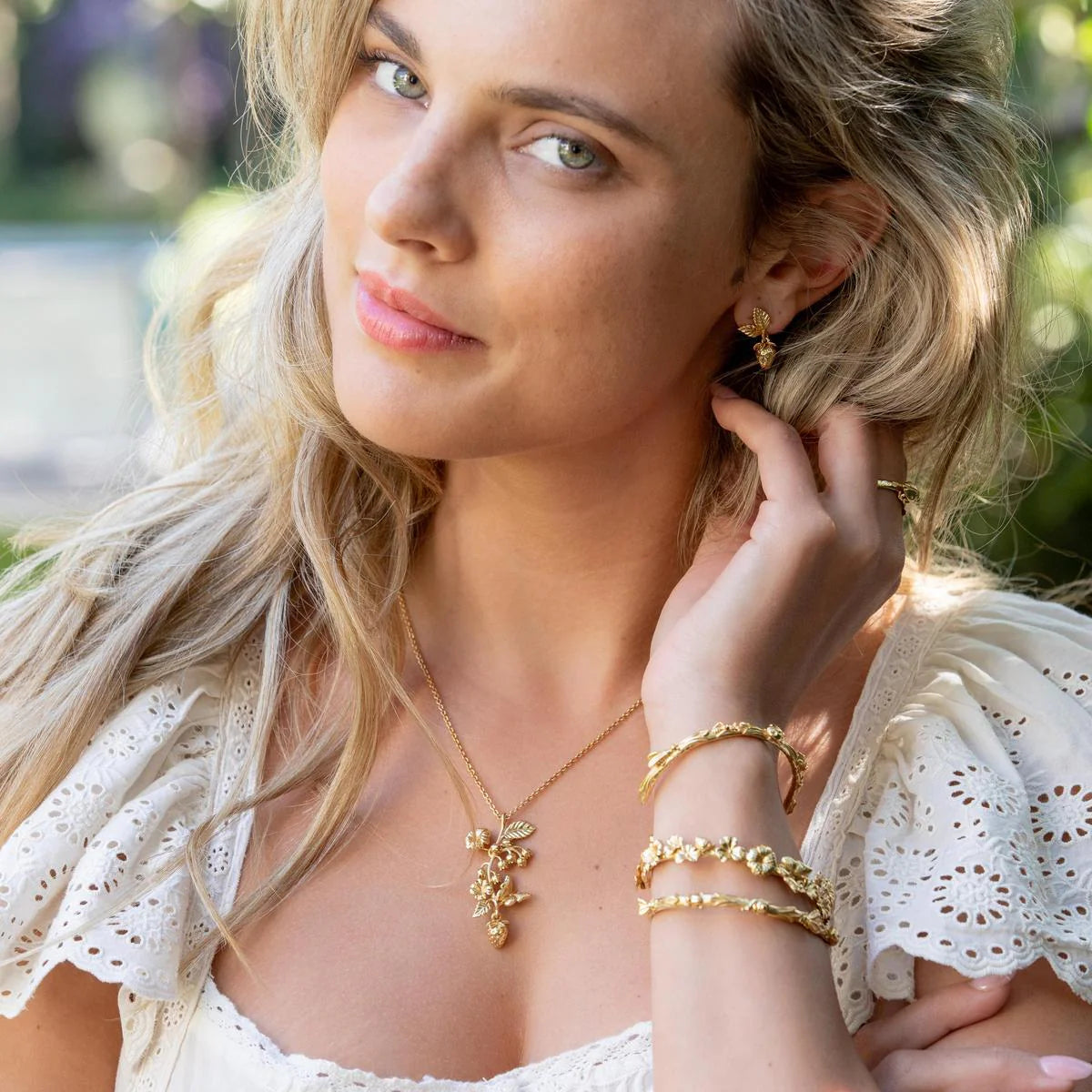 Woman wearing gold jewelry outdoors