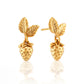 Gold strawberry-shaped earrings on a white background