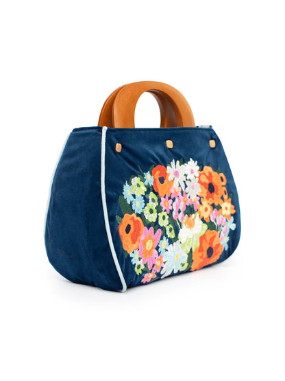 Navy blue handbag with colorful floral design on a white background