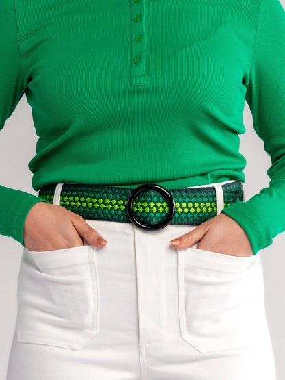 Person wearing a green shirt and white pants with a green belt featuring a black buckle.