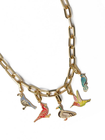 Gold chain necklace with colorful bird charms on a white background