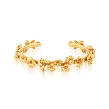 Gold bracelet with floral designs on a white background