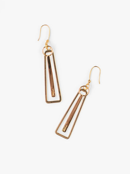 Gold geometric earrings on a white background