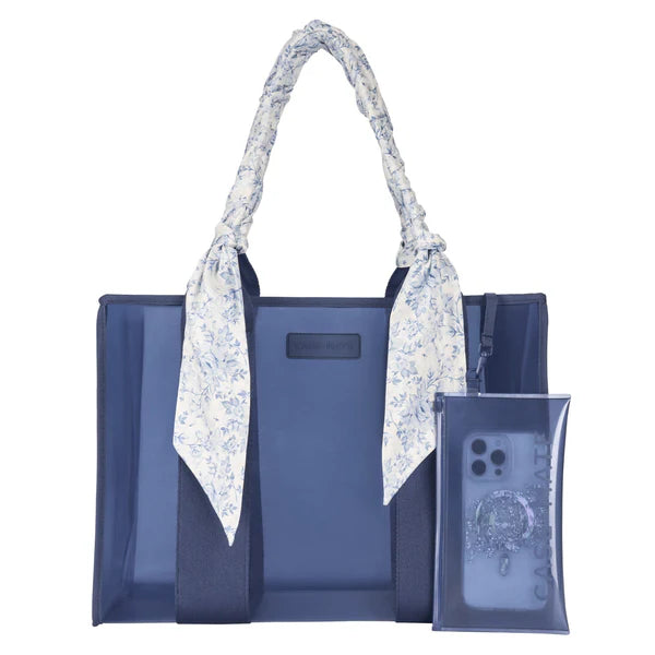 Blue tote bag with floral handle and clear phone case on a white background
