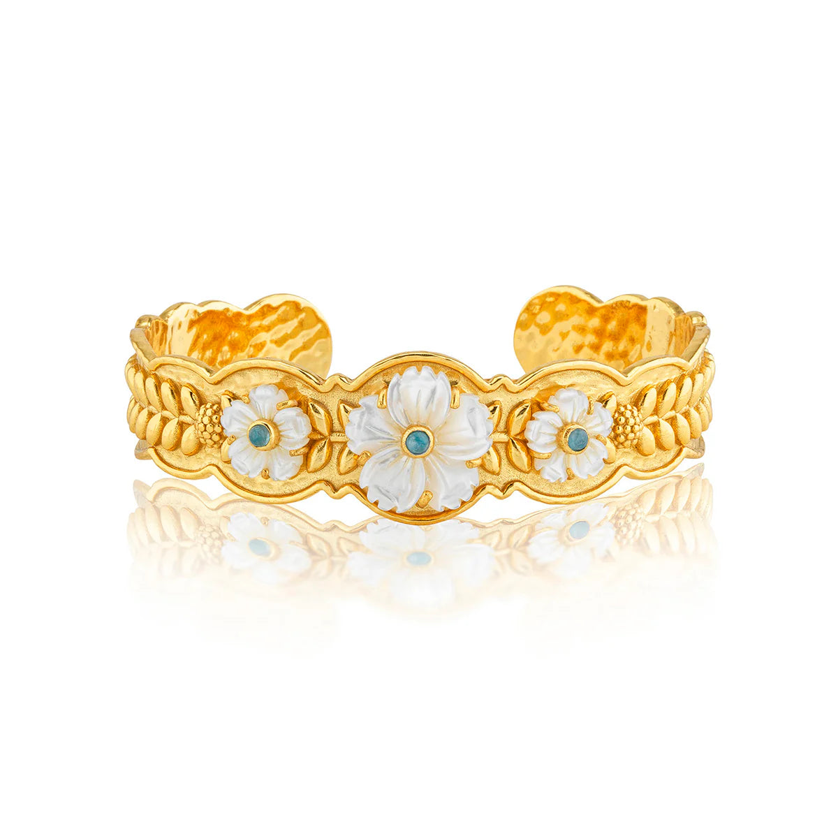 Gold bracelet with floral designs on a white background