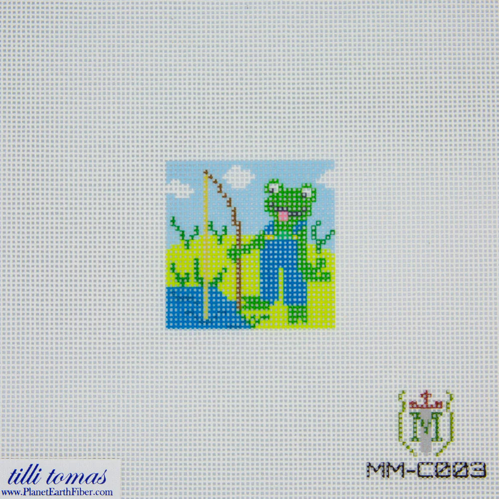 Cross-stitched design of a frog in overalls holding a fishing rod on fabric.