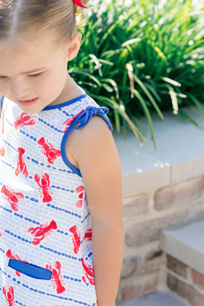 Young girl wearing a dress with lobster print outdoors