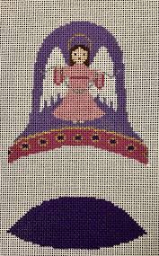 A needlepoint canvas design featuring a stylized angel with wings in shades of purple, pink, and white, set against a beige grid canvas background with a large dark purple shape at the bottom.