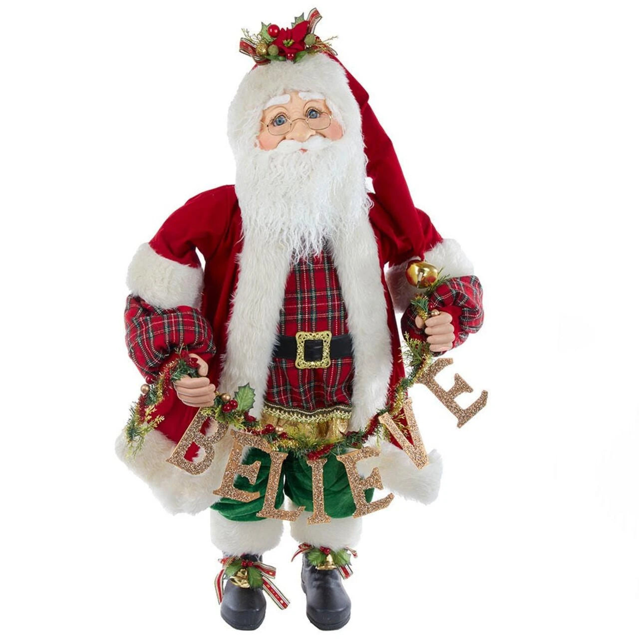 A Santa Claus figurine wearing a red coat with white fur trim, a red and green plaid shirt, black boots, and a white beard, holding a gold glittery 'BELIEVE' banner with holly accents, on a white background.