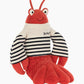 Plush toy lobster with striped shirt on a white background