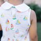 Child wearing a sleeveless shirt with sailboat pattern outdoors