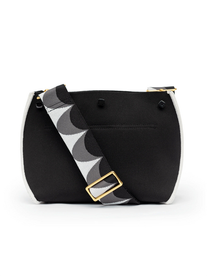 Black handbag with a patterned strap on a white background