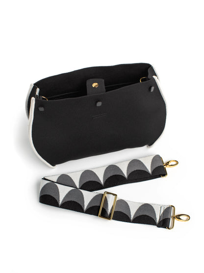 Black pouch with a patterned strap on a white background