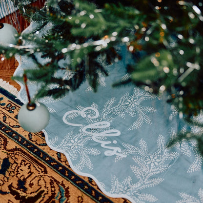 Decorative tablecloth with 'Ellis' print under a Christmas tree