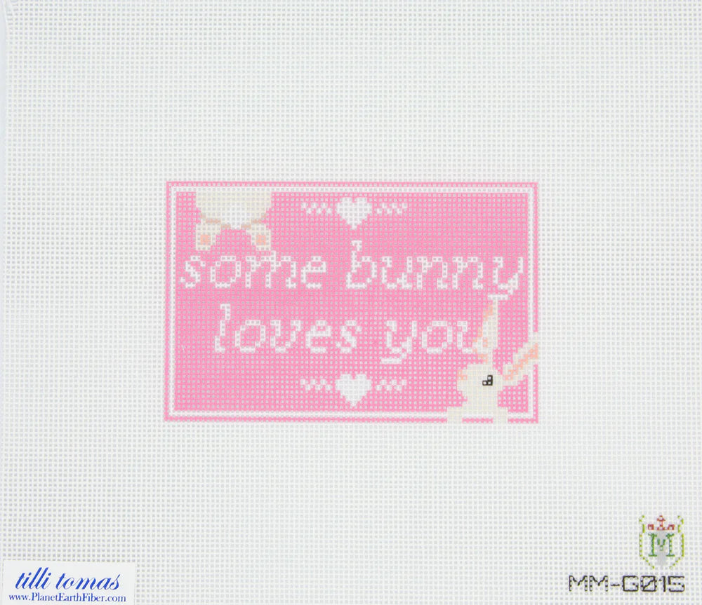 Cross-stitched pattern with 'some bunny loves you' text on a pink background