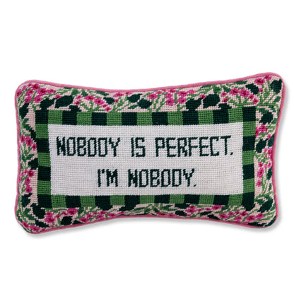 Decorative pillow with floral border and text 'Nobody is perfect. I'm nobody' on a white background