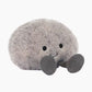 Plush toy whale with a bow tie on a white background
