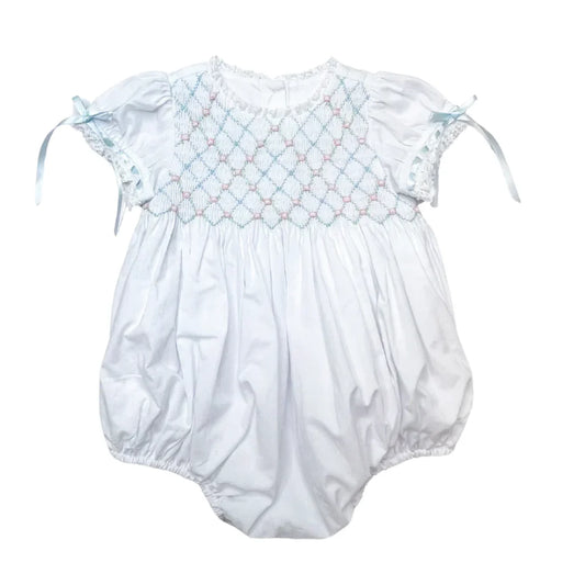 Baby romper with smocked bodice on a white background