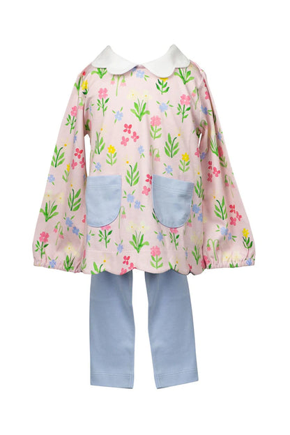 Children's outfit with floral dress and blue pants on a white background