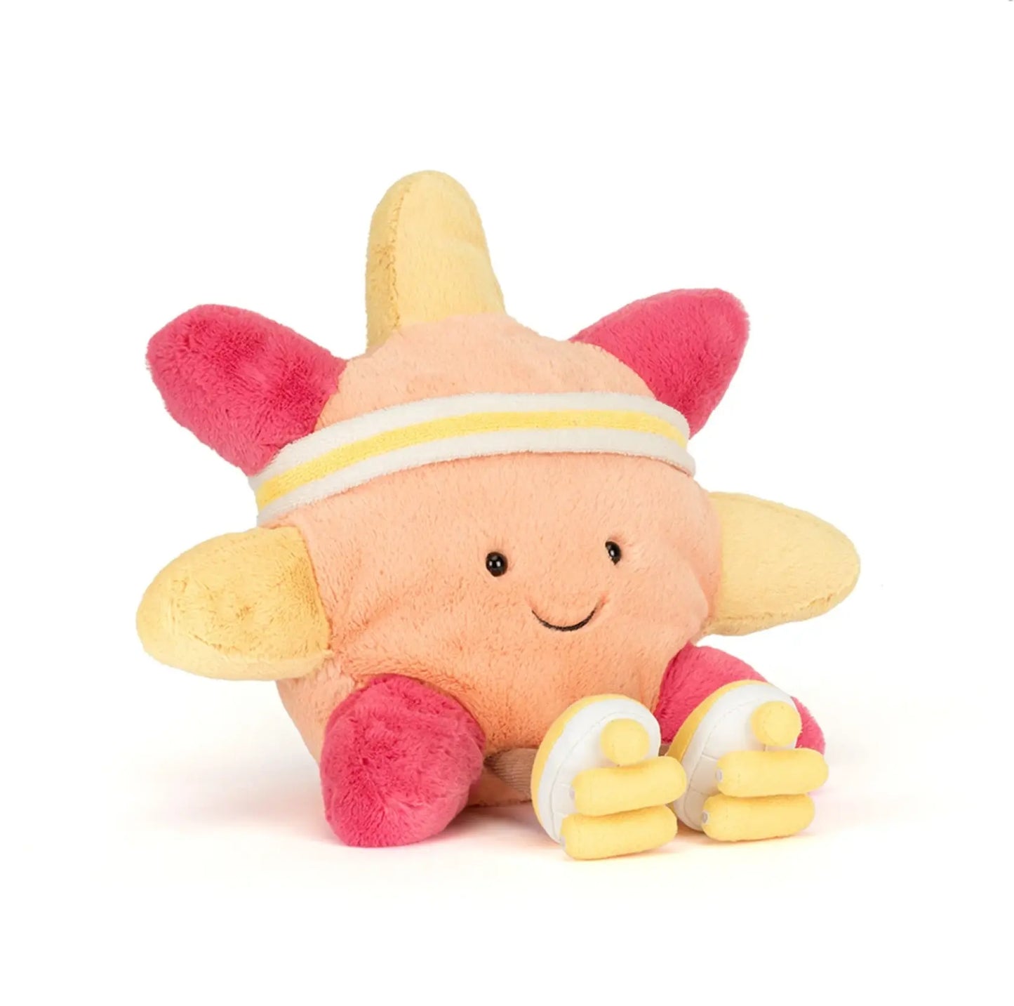 Plush toy starfish with pink and yellow colors on a white background