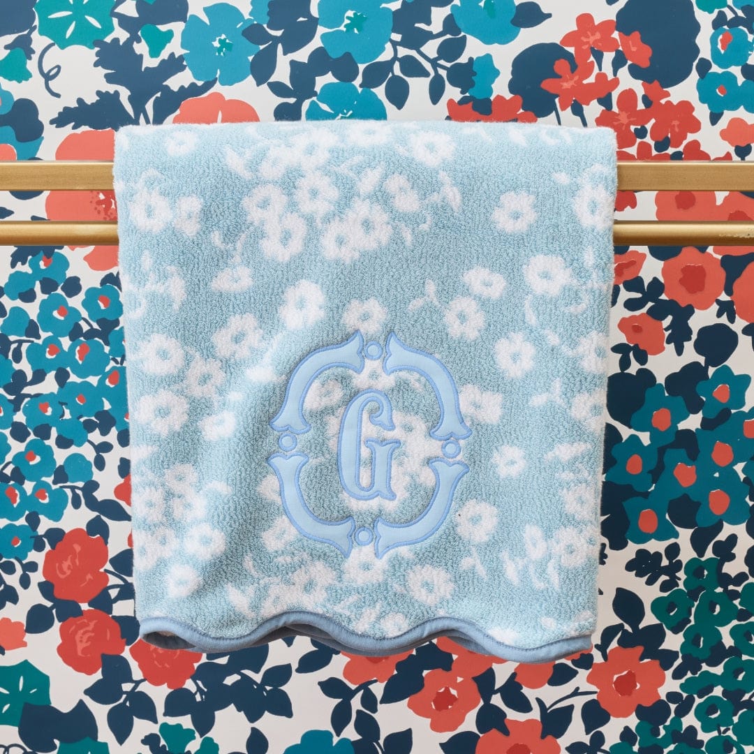 Floral-patterned towel with a blue floral design on a colorful floral background