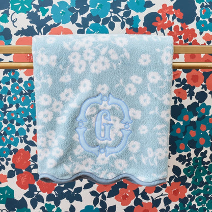 Floral-patterned towel with a blue floral design on a colorful floral background