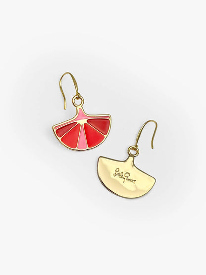 Two earrings with red and gold designs on a white background