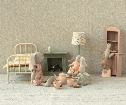 Children's room with toys and furniture including a bed, cabinet, and lamp.